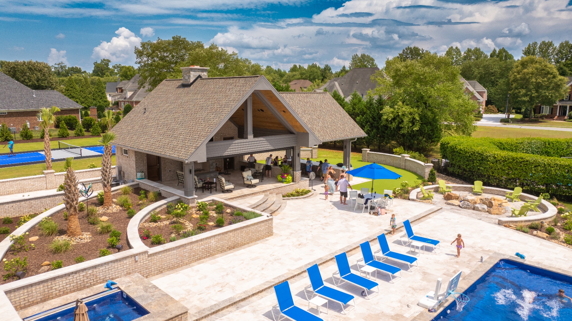 Completed Bluevue outdoor living project with pool house, pool, and patio