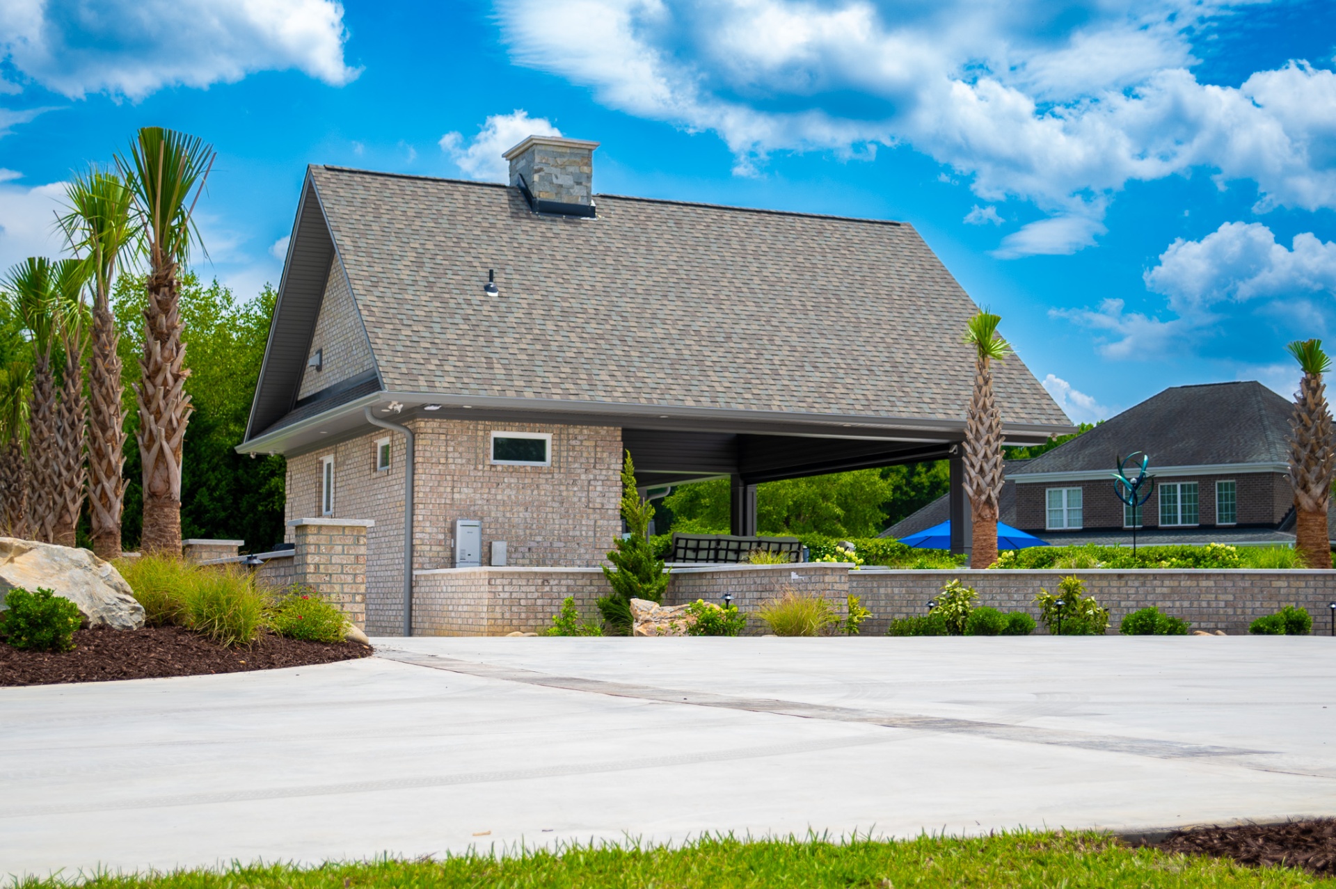 Cabana exterior with palm landscaping and concrete drive