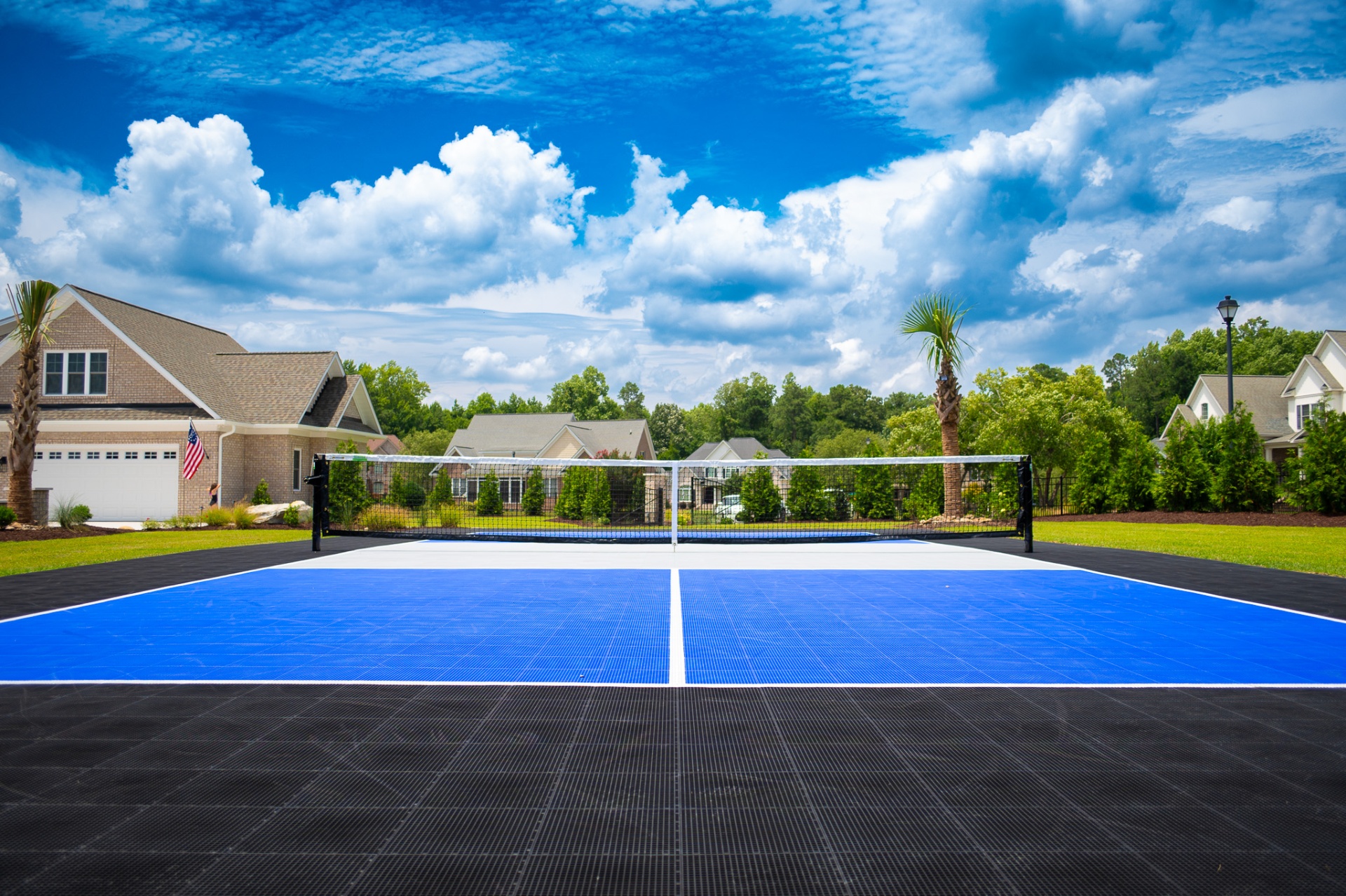 Backyard pickleball court with blue playing surface